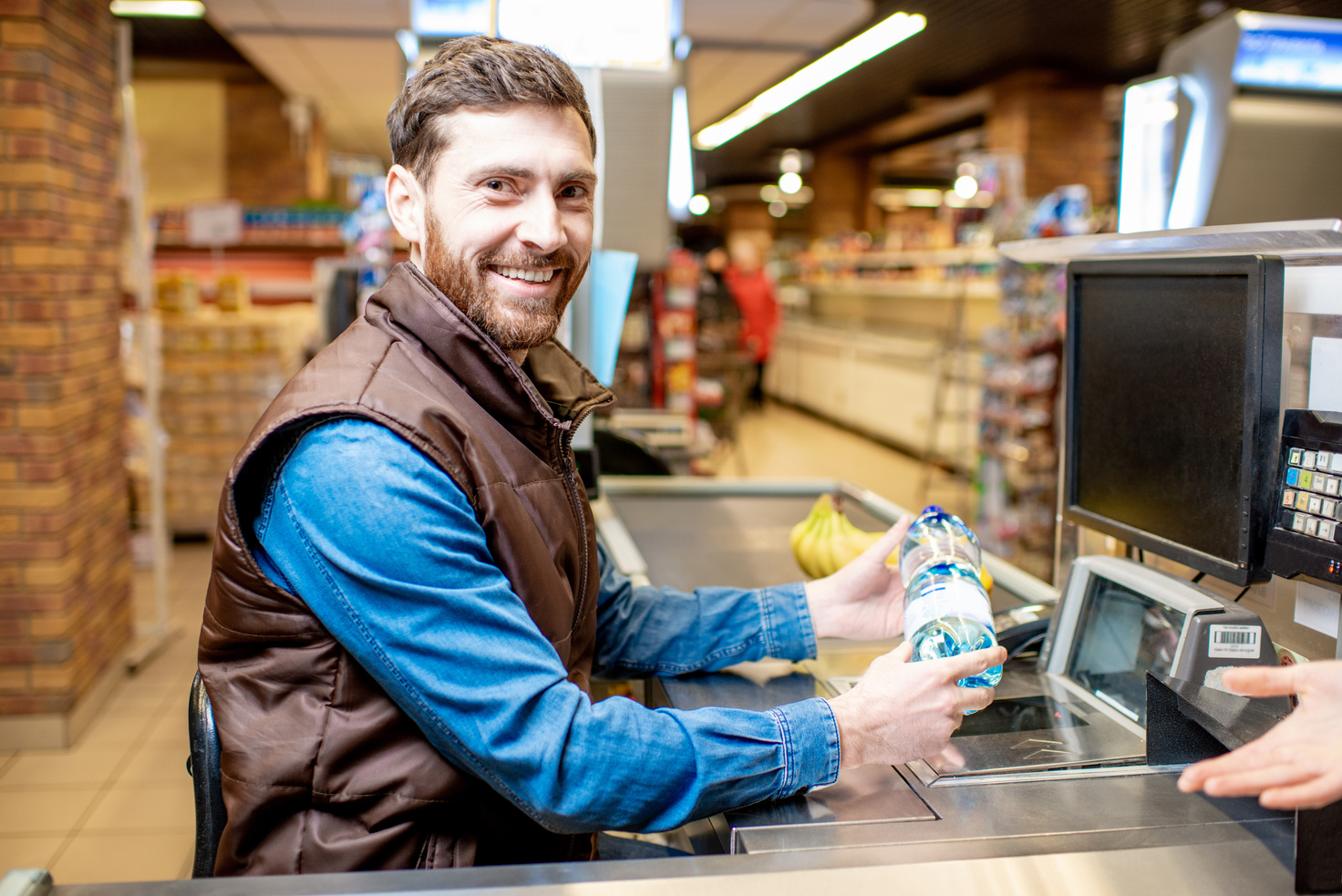 Happy Cashier at the Cash Register